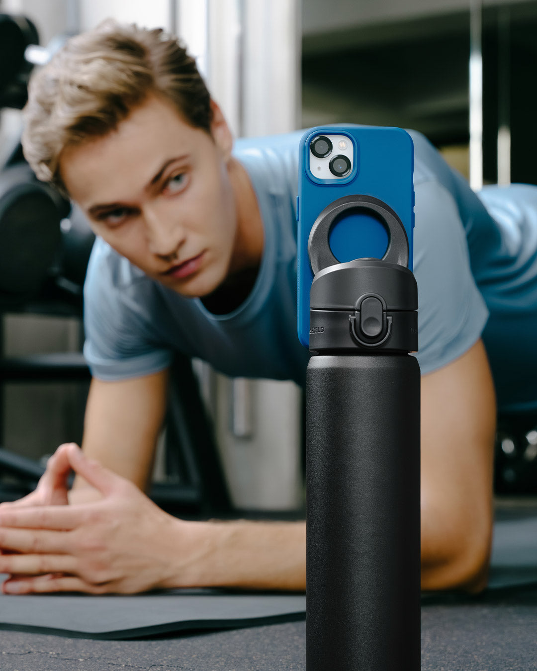 Water bottle with magnetic phone mount attached