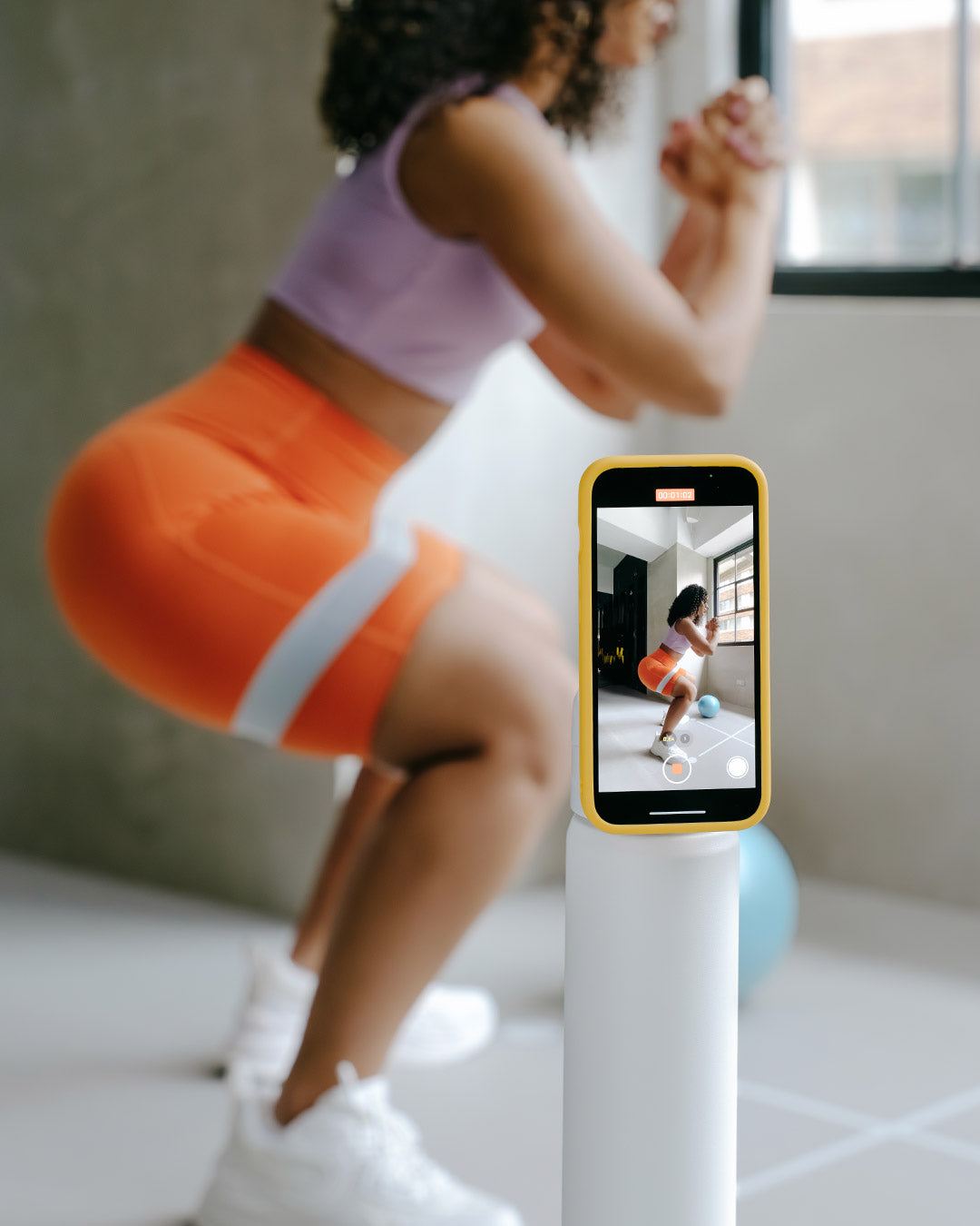 Phone propped on bottle at the gym